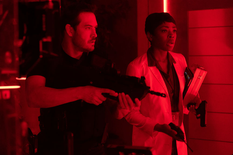 Agent Wolgast (Mark-Paul Gosselaar) and Dr. Sykes (Caroline Chikezie) brace for impact;